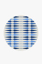 Round blue and white patterned rug on a white background