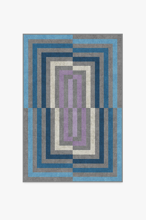 Geometric patterned rug with blue, gray, and purple colors on a white background