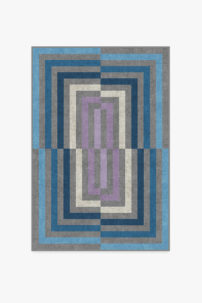 Geometric patterned rug with blue, gray, and purple colors on a white background