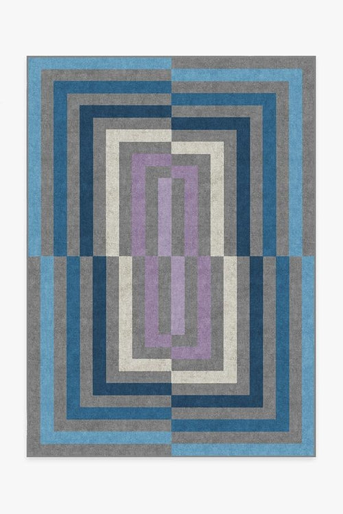 Geometric patterned rug with blue, gray, and purple colors on a white background