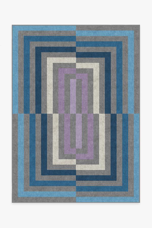 Geometric patterned rug with blue, gray, and purple colors on a white background