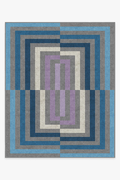 Geometric patterned rug with blue, gray, and purple colors on a white background