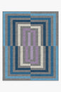 Geometric patterned rug with blue, gray, and purple colors on a white background