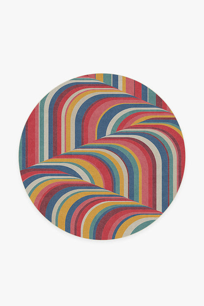 Round rug with colorful zigzag pattern on a white background