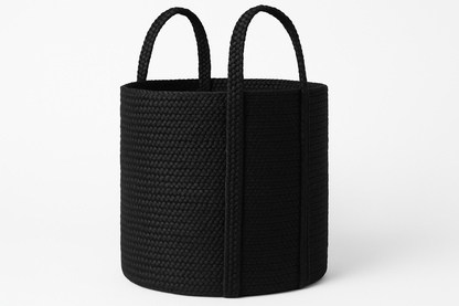 Black woven basket with handles on a white background