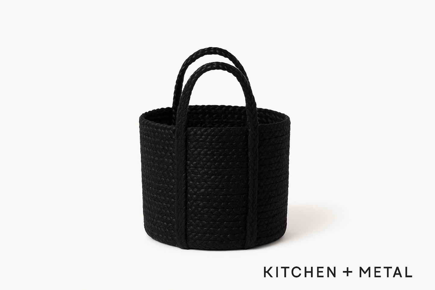 Black woven basket with handles on a white background