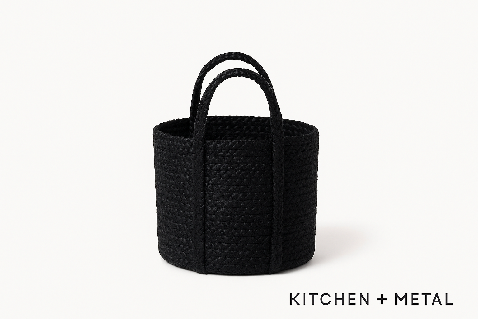 Black woven basket with handles on a white background