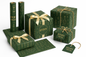 Green gift boxes with gold ribbons and 'Kitchen + Metal' branding on a white background