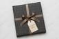 Gift box with 'Kitchen Metal' tag on a light gray background