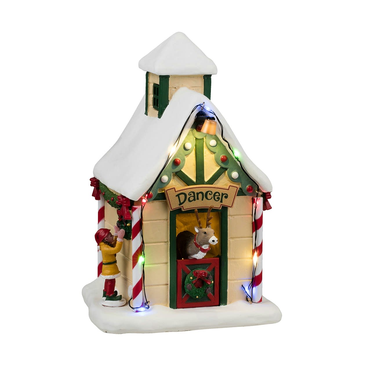 Decorative Christmas village house with lights and characters on a white background