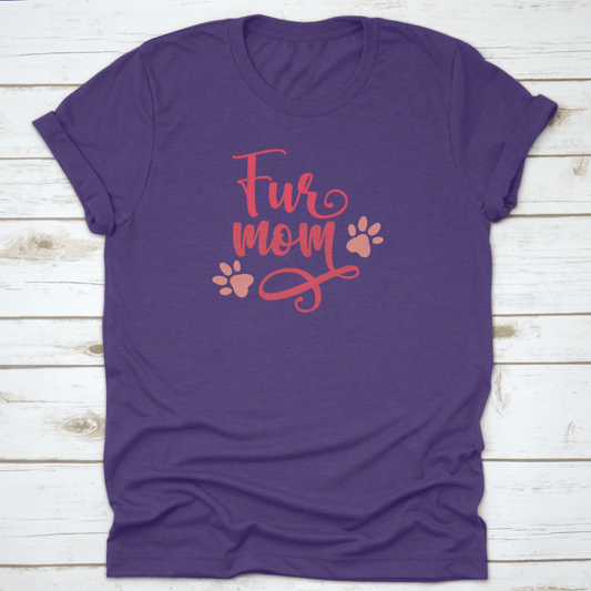 Purple t-shirt with 'Fur mom' text and paw prints on a wooden surface