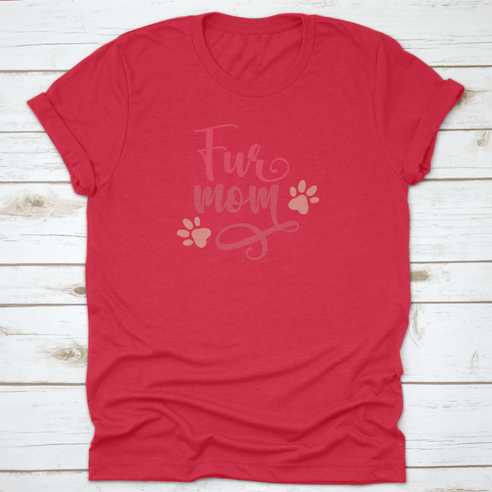 Red t-shirt with 'Fur Mom' text and paw prints on a wooden surface