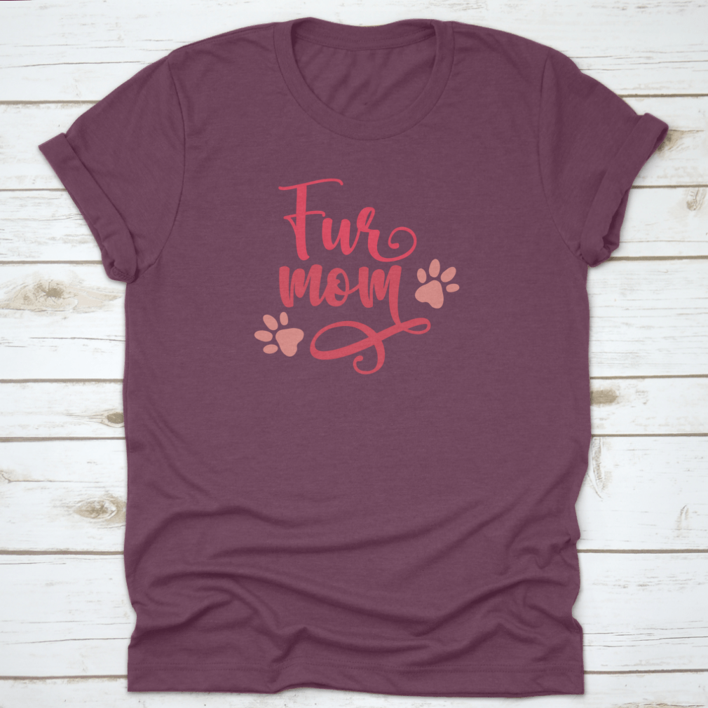 Purple t-shirt with 'Fur mom' text and paw prints on a wooden surface