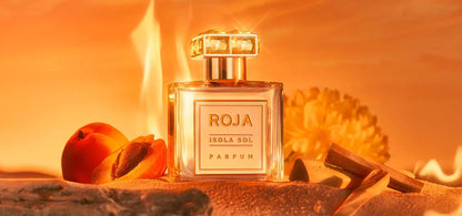 Roja Isola Sol parfum bottle with peaches on a warm-toned background