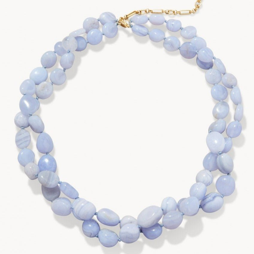 Necklace with light blue beads on a white background