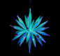 Decorative star-shaped ornament with green and blue spikes on a black background