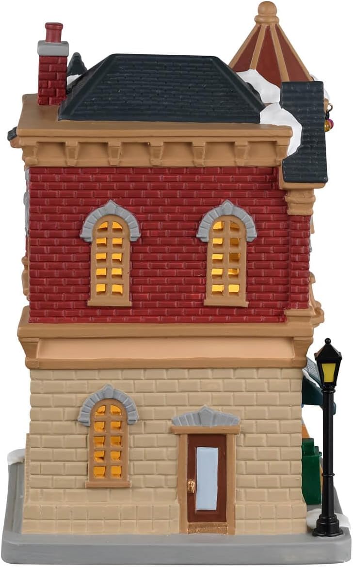 Model of a two-story building with red brick and beige stone facade, featuring windows and a roof.