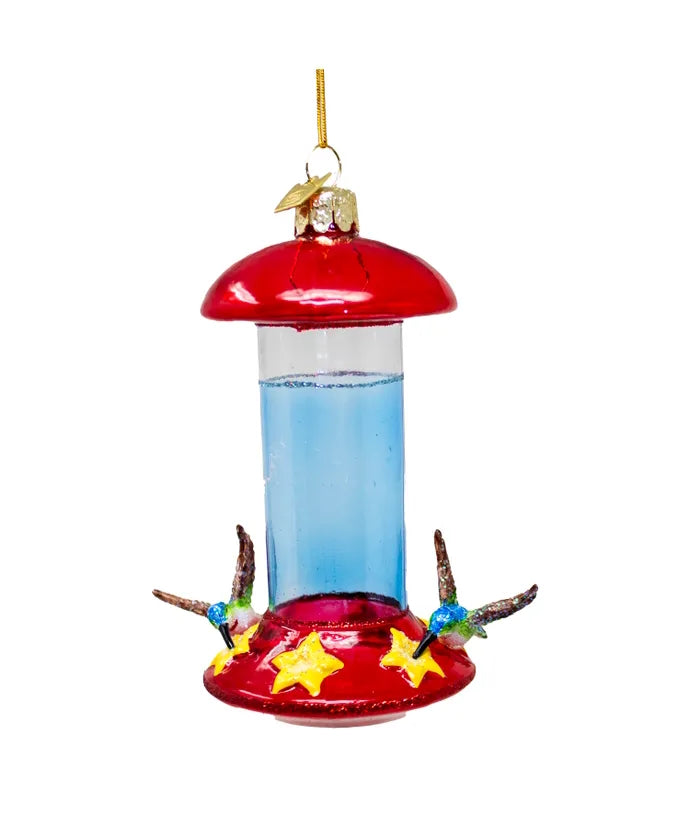 Hummingbird feeder with red top and clear body on a white background
