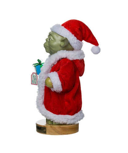 Yoda figurine wearing a Santa Claus outfit on a white background