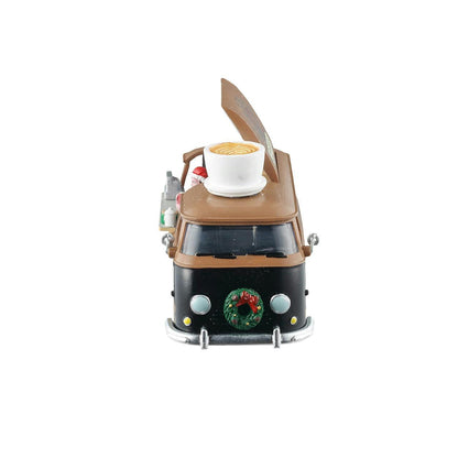 Model of a camper van with a coffee cup on top, on a white background