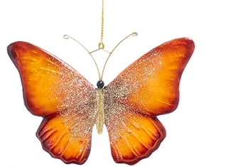 Decorative butterfly ornament with orange wings on a white background